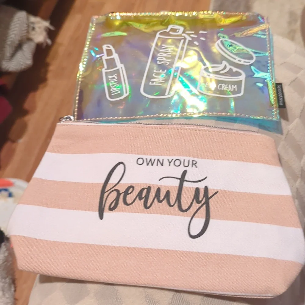 Cosmetic Bag Cases. Two. One Is Pink And White. One Is Shiny Pink.